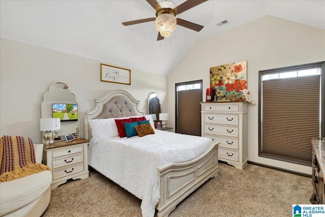 bedroom with multiple windows, a ceiling fan, vaulted ceiling, and light colored carpet