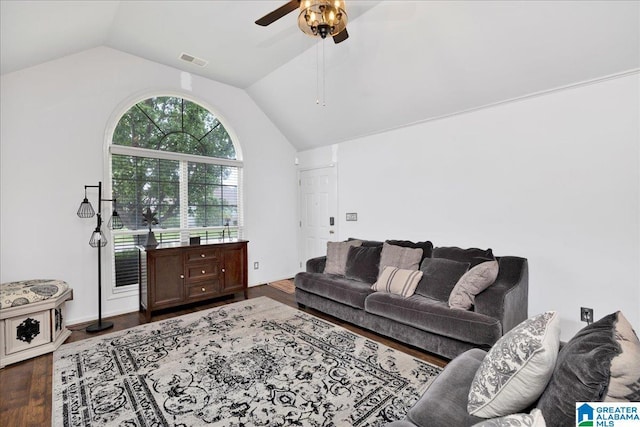 living area featuring ceiling fan, visible vents, dark wood-style floors, and vaulted ceiling