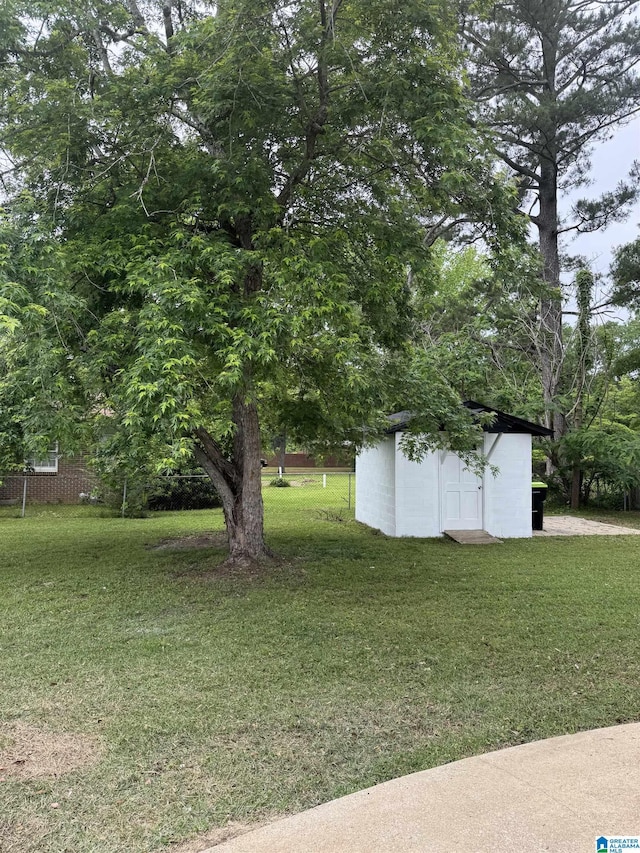 view of yard with a storage unit and an outbuilding