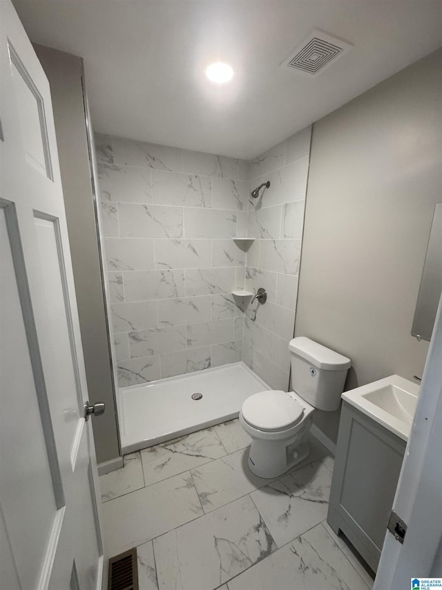 bathroom with toilet, visible vents, tiled shower, and marble finish floor