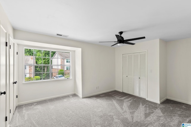 unfurnished bedroom featuring visible vents, carpet flooring, and baseboards