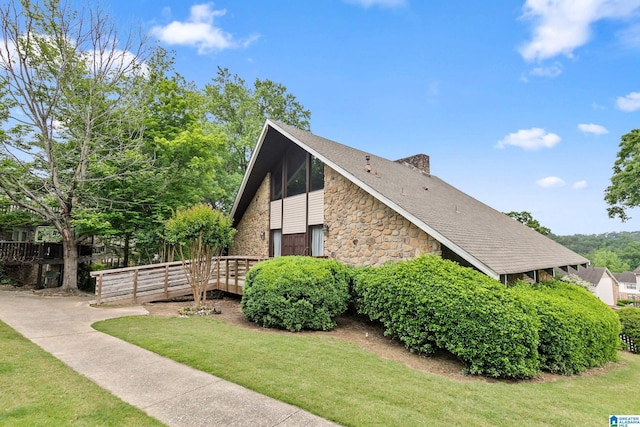 view of home's exterior with a yard and stone siding