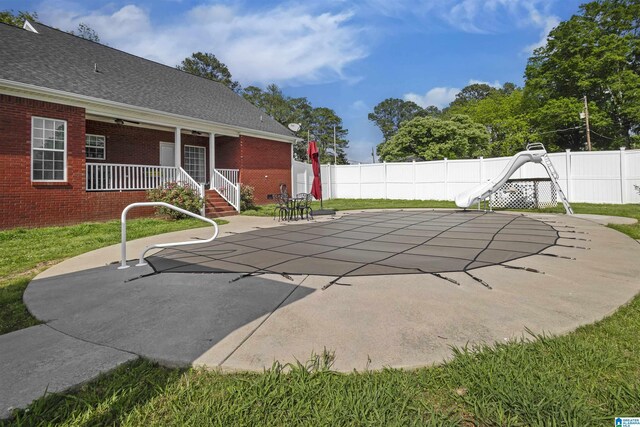 1018 Sheraton Rd SW, Cullman, AL 35055 - view of pool featuring a fenced in pool, a fenced backyard, a patio area, and a water slide