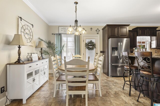 1018 Sheraton Rd SW, Cullman, AL 35055 - dining room with crown molding, stone finish floor, and a notable chandelier