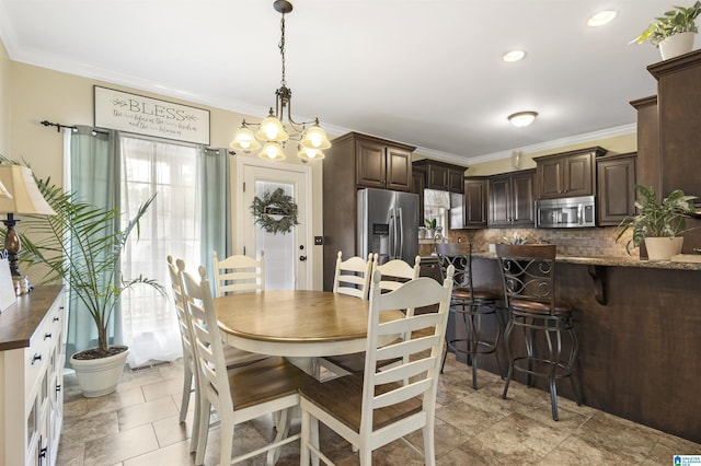 1018 Sheraton Rd SW, Cullman, AL 35055 - dining space featuring crown molding and a notable chandelier