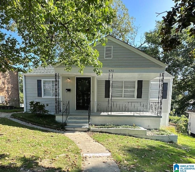 bungalow-style home featuring a porch and a front lawn