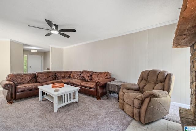 living area featuring ornamental molding, light carpet, and a ceiling fan