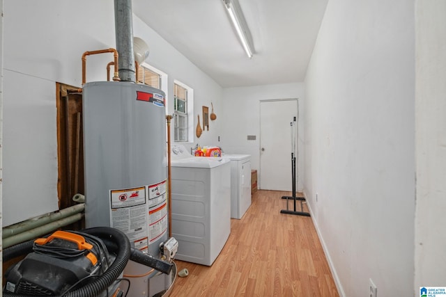 clothes washing area featuring light wood-style floors, separate washer and dryer, laundry area, and gas water heater