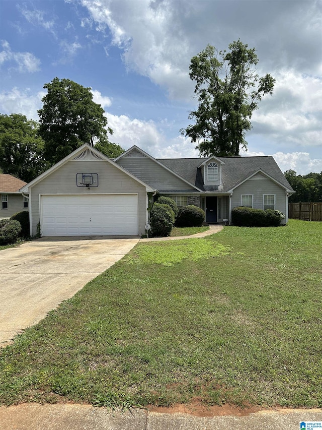 view of front of property with fence, driveway, a front lawn, and a garage