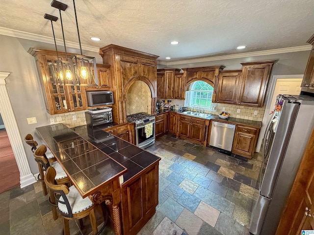 166 Hickory Ridge Dr, Glencoe, AL 35905 - kitchen featuring stainless steel appliances, a peninsula, stone tile flooring, brown cabinets, and recessed lighting