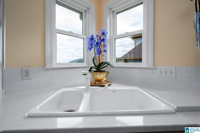 room details featuring tasteful backsplash and light countertops