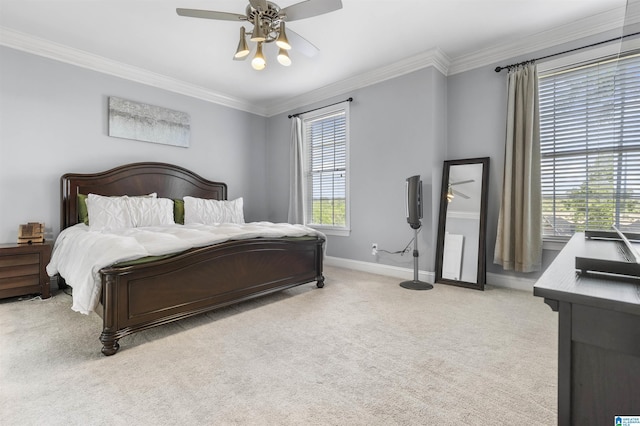 carpeted bedroom featuring baseboards, ornamental molding, and ceiling fan