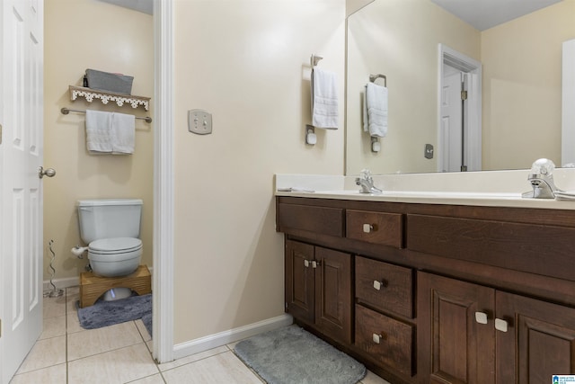 full bath featuring double vanity, baseboards, toilet, and tile patterned flooring