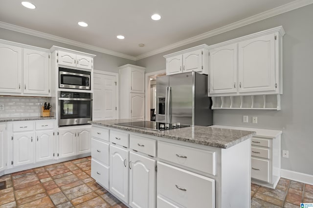kitchen with stainless steel appliances, white cabinetry, stone finish flooring, recessed lighting, and a kitchen island