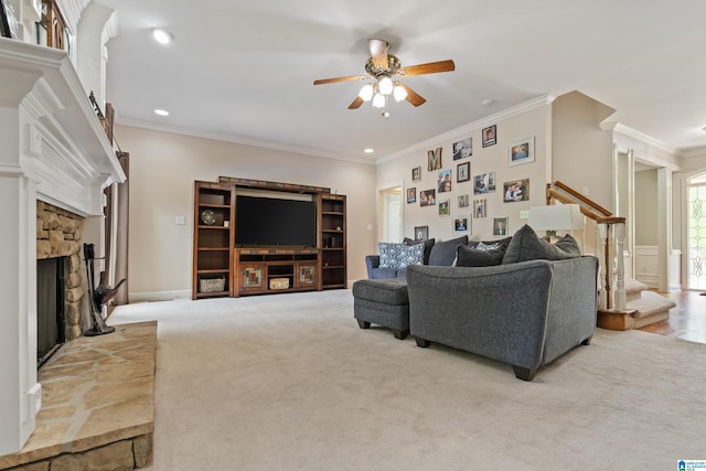carpeted living room featuring crown molding, a fireplace, a ceiling fan, recessed lighting, and stairway