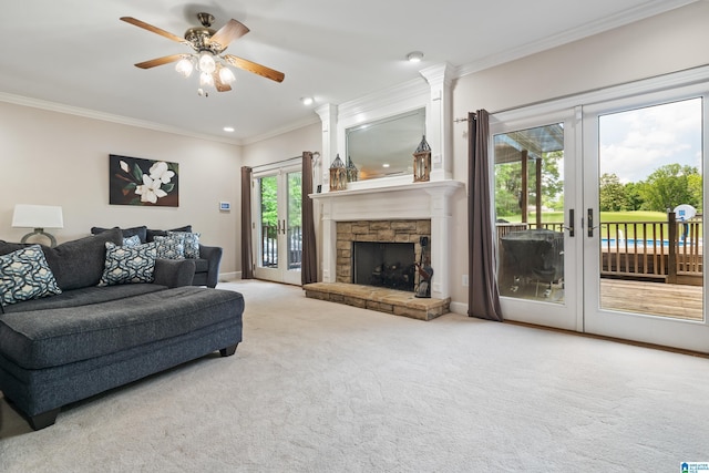 living room featuring crown molding, baseboards, ceiling fan, french doors, and carpet