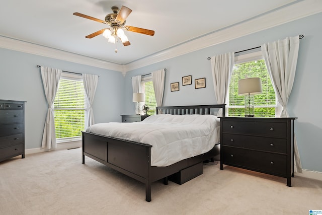 bedroom featuring crown molding, ceiling fan, light colored carpet, and baseboards