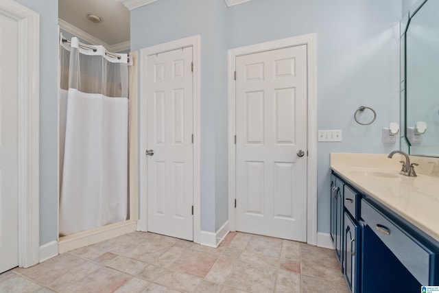 bathroom featuring crown molding, baseboards, a shower with shower curtain, and vanity
