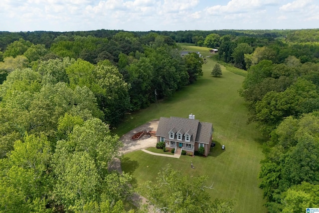 drone / aerial view featuring a view of trees