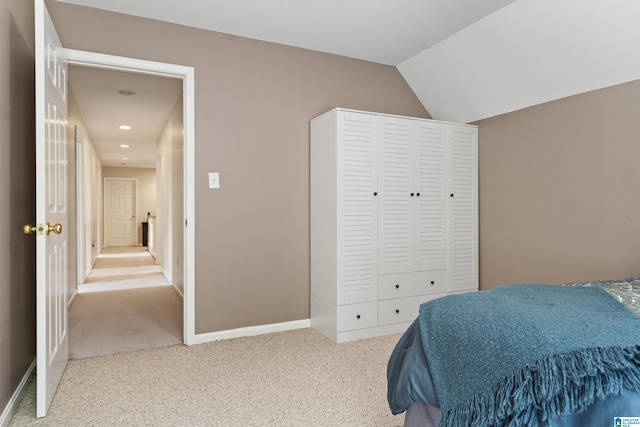 carpeted bedroom with recessed lighting, baseboards, lofted ceiling, and a closet