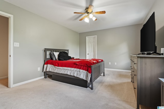 bedroom featuring a ceiling fan, baseboards, and light colored carpet