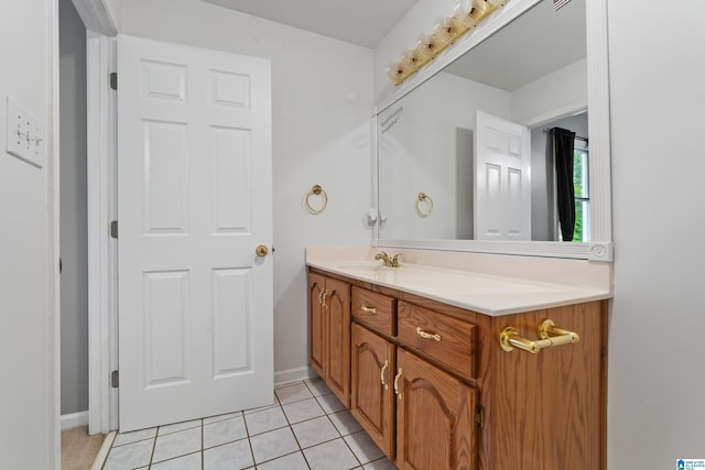 bathroom featuring tile patterned floors, baseboards, and vanity