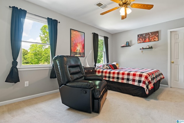 bedroom featuring carpet floors, visible vents, and multiple windows