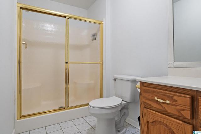 bathroom with vanity, tile patterned flooring, a stall shower, and toilet