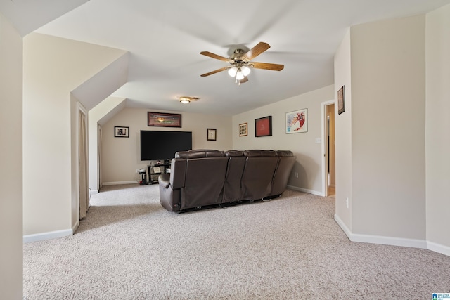 carpeted living room featuring baseboards and ceiling fan