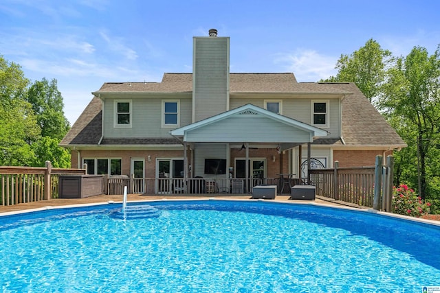 view of pool with ceiling fan and a fenced in pool