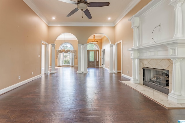 306 Oak Leaf Ln, Glencoe, AL 35905 - unfurnished living room with crown molding, a fireplace, arched walkways, hardwood / wood-style flooring, and a ceiling fan