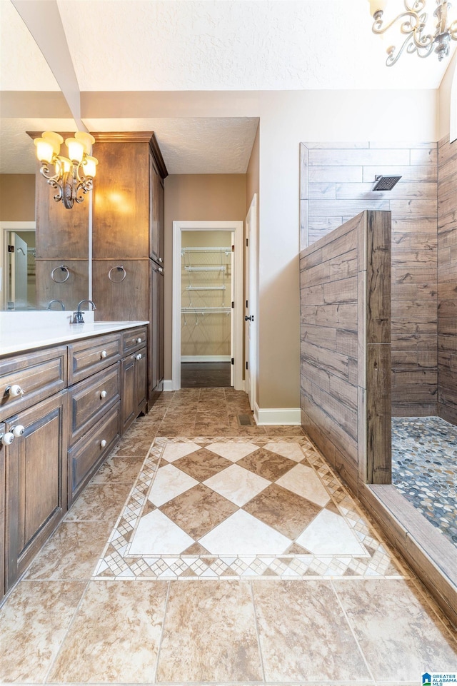 306 Oak Leaf Ln, Glencoe, AL 35905 - full bath with vanity, baseboards, walk in shower, and a notable chandelier