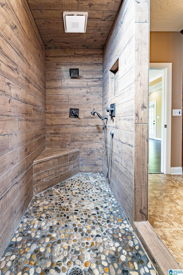 306 Oak Leaf Ln, Glencoe, AL 35905 - bathroom with wooden walls, stone floors, a tile shower, and wood ceiling