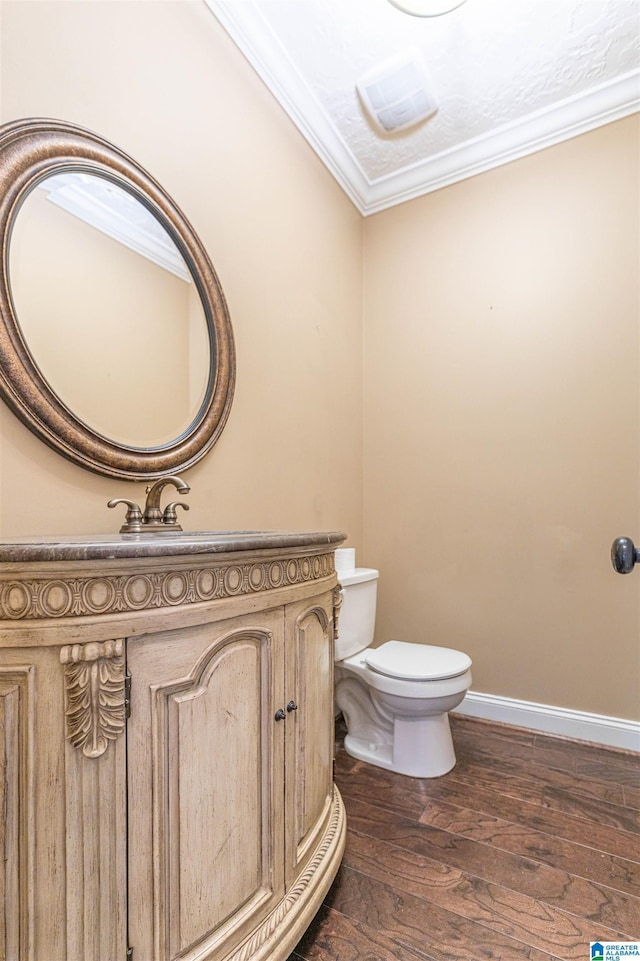 306 Oak Leaf Ln, Glencoe, AL 35905 - half bathroom with crown molding, baseboards, toilet, and wood finished floors