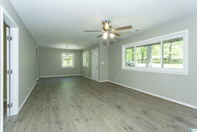 spare room with baseboards, a ceiling fan, and wood finished floors