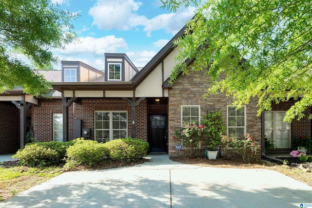 view of front of home featuring brick siding and stone siding