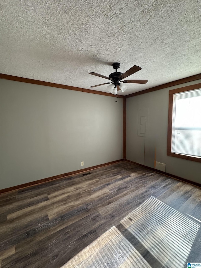 spare room featuring a textured ceiling, baseboards, a ceiling fan, and wood finished floors