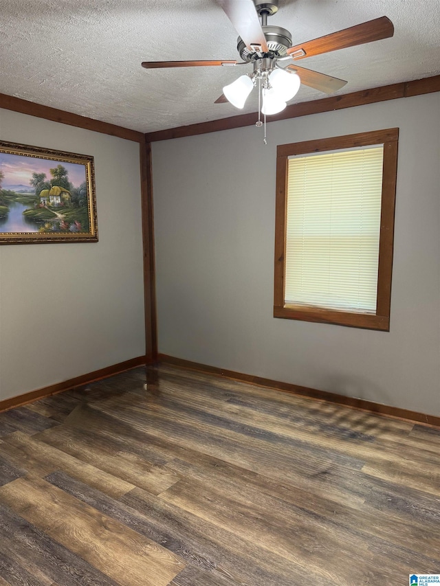 unfurnished room with a textured ceiling, ceiling fan, dark wood-style floors, and baseboards