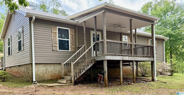 rear view of house featuring a deck, a ceiling fan, and metal roof