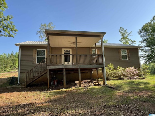 rear view of house featuring stairway, ceiling fan, a wooden deck, and metal roof