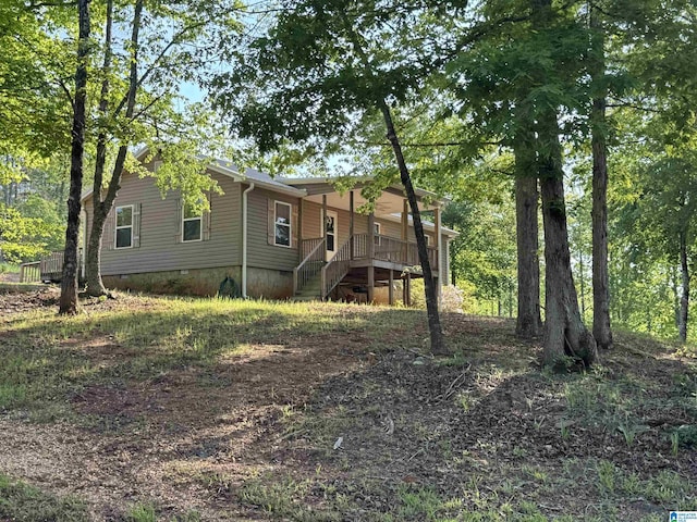 exterior space featuring stairway and crawl space