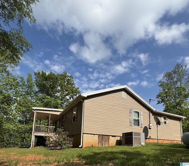 view of home's exterior featuring a lawn and cooling unit