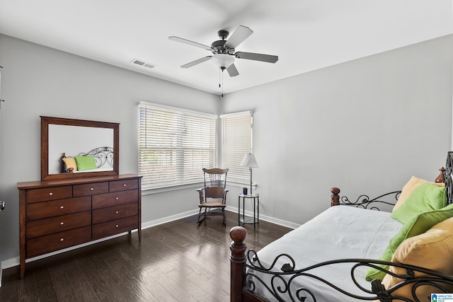 bedroom featuring baseboards, a ceiling fan, wood finished floors, and visible vents