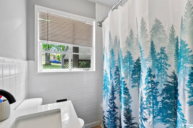 full bath with tile walls and a shower with curtain