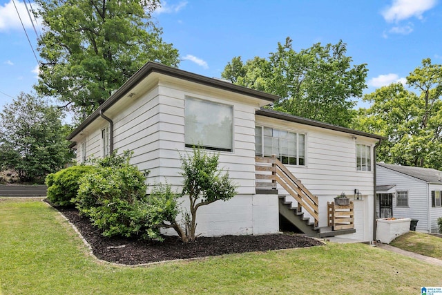 ranch-style home featuring stairs and a front yard