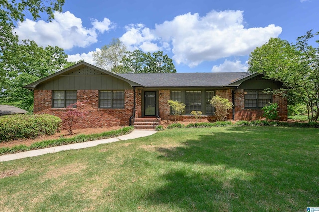 single story home with brick siding and a front lawn
