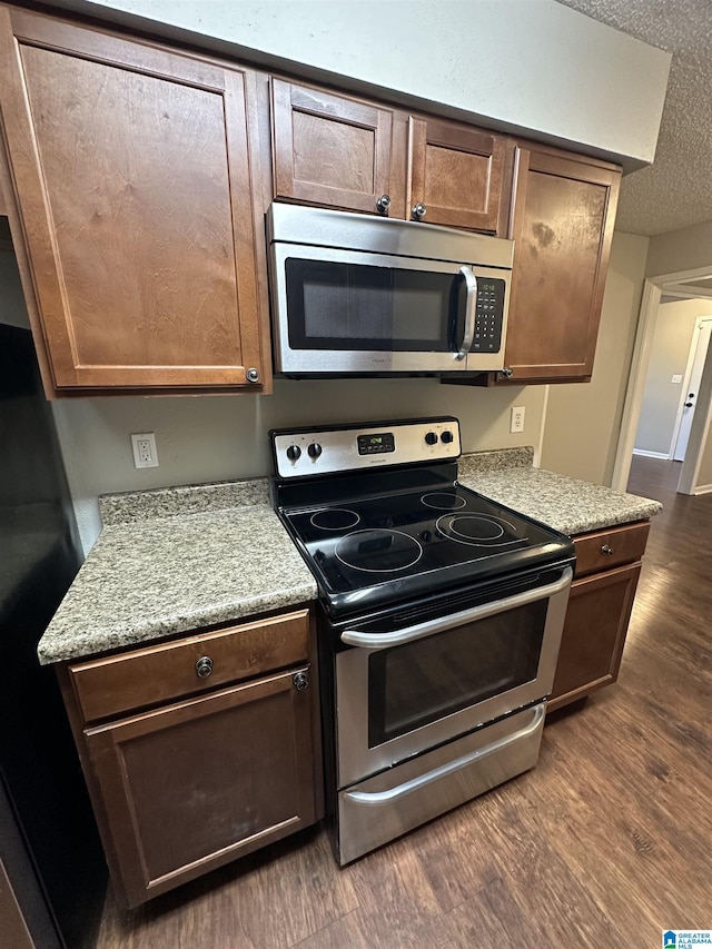 2003 Patton Creek Dr Unit 2003, Hoover, AL 35226 - kitchen featuring light countertops, stainless steel appliances, dark wood finished floors, and a textured ceiling