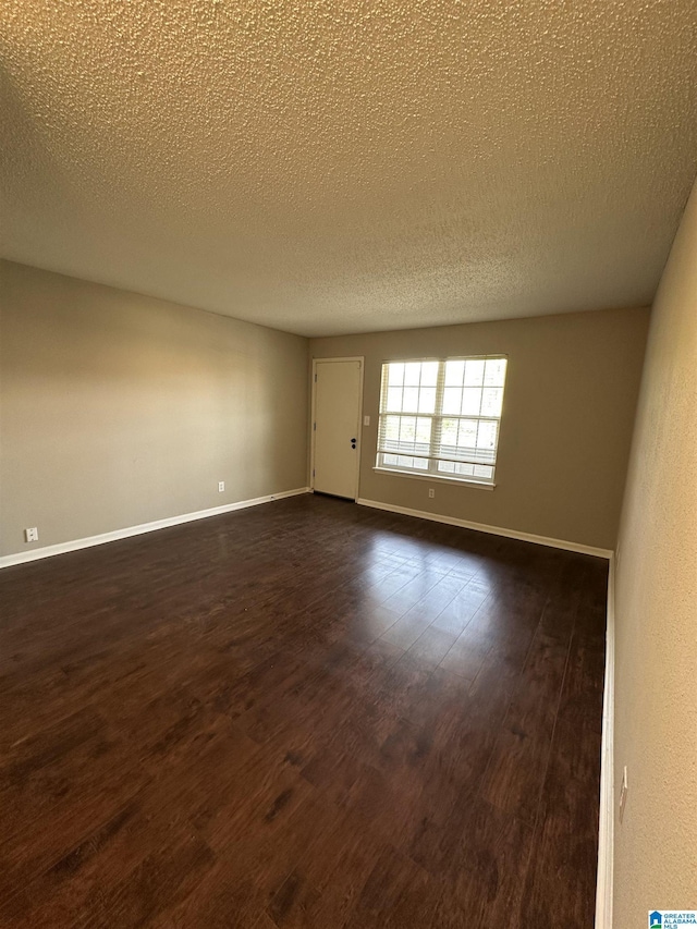 2003 Patton Creek Dr Unit 2003, Hoover, AL 35226 - spare room with baseboards, a textured ceiling, and dark wood-style flooring