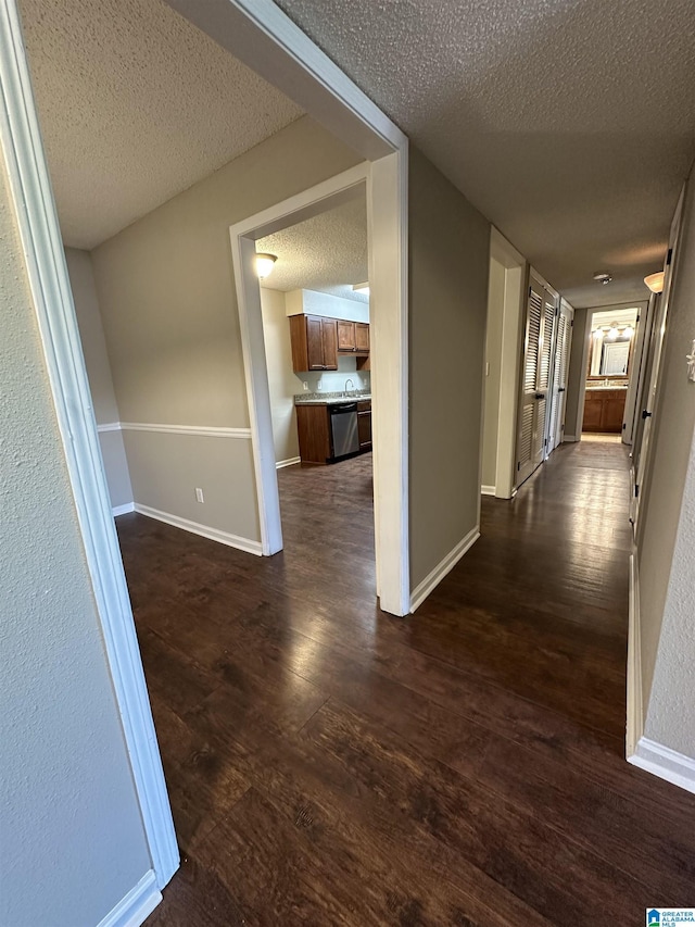 2003 Patton Creek Dr Unit 2003, Hoover, AL 35226 - hall featuring a textured ceiling, baseboards, and dark wood-type flooring