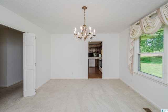 unfurnished dining area featuring a textured ceiling, visible vents, baseboards, a notable chandelier, and carpet flooring